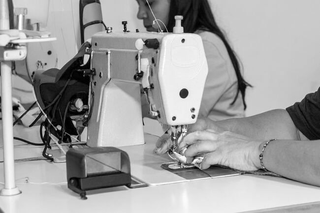 A close up of women stitching
