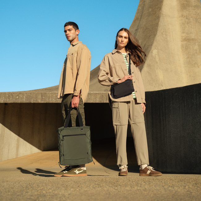 A man and woman standing in an open space with Quadra Products