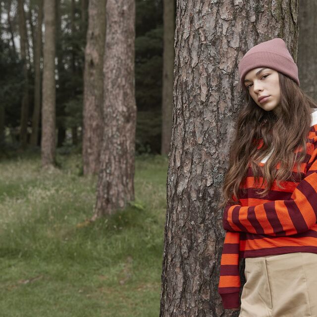 A woman wearing a Organic Beanie stood in the woods